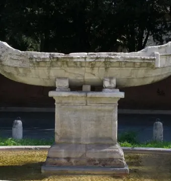 Fontana della Navicella stone boat sculpture on a pedestal in a fountain basin