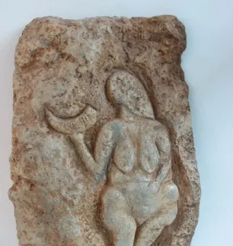 Venus of Laussel stone relief showing a nude female figure holding a crescent-shaped horn