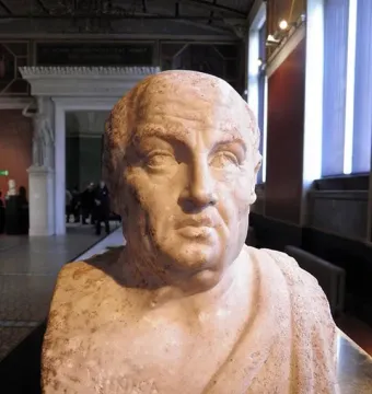 Double herm of Socrates and Seneca, showing the inscribed bust of Seneca in a museum gallery.