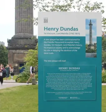 Information sign for Henry Dundas stands in front of the Melville Monument\'s stone base.