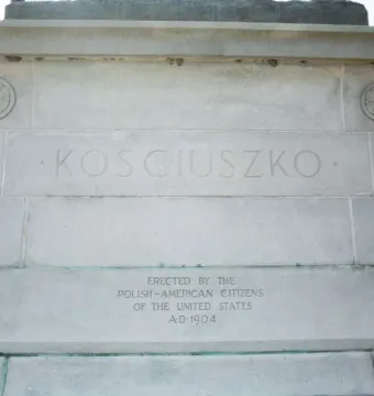 Stone base of the Tadeusz Kościuszko Monument with the carved name Kosciuszko and dedication text.