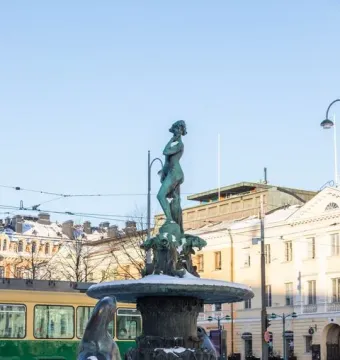 Havis Amanda fountain topped with a female figure and surrounded by marine sculptures, covered in snow.