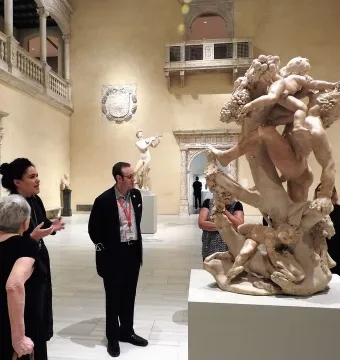 Marble sculpture A Faun Teased by Children showing a bearded faun surrounded by playful children figures.