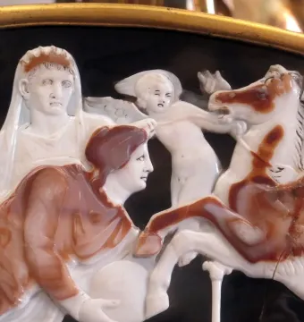 Great Cameo of France showing carved figures in layered relief, including a crowned woman, a winged child, a draped figure, and a rearing horse.