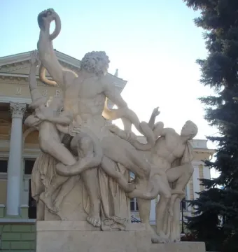 The Laocoön sculpture shows a marble man and two boys struggling with giant serpents on a pedestal.