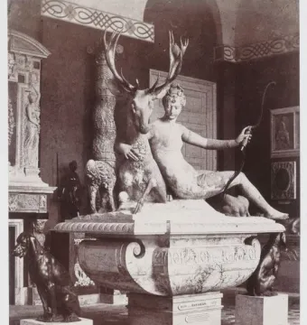 The Fountain of Diana, a marble sculpture of a nude woman with a bow embracing a stag, with two dogs on the basin below.