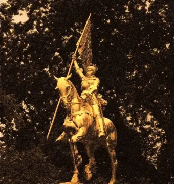Joan of Arc equestrian statue with an armored rider holding a flag aloft.