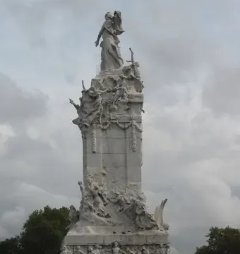 The Monument to the Carta Magna and the Four Regions of Argentina, a tall white stone sculpture with a standing female figure on top and detailed reliefs below.