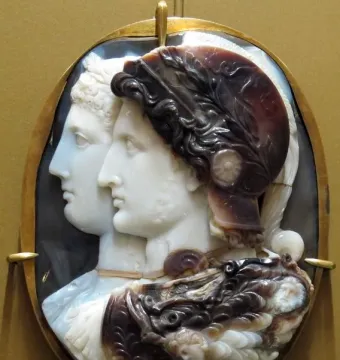 Gonzaga Cameo showing two carved profile portraits in a gold frame, with a helmeted figure in front and another profile behind.