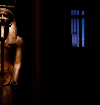 Ka statue of King Hor, a dark wooden ancient Egyptian figure with a pharaonic headdress and false beard.