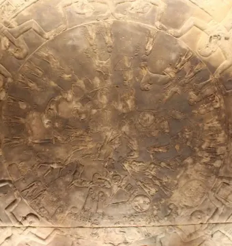 The Dendera Zodiac, a circular stone relief densely carved with figures and symbols.