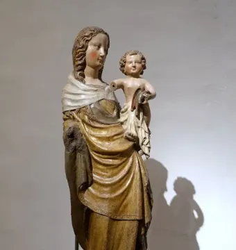 Friesentor Madonna, a painted wooden Madonna and Child sculpture with gilded drapery, the child resting on her hip with one arm missing.