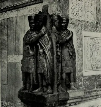 Portrait of the Four Tetrarchs, a dark stone sculpture of four helmeted figures holding swords and embracing in pairs.