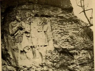 Ivriz relief showing two carved figures on a rock face, one holding a cluster of objects and the other raising an object overhead.