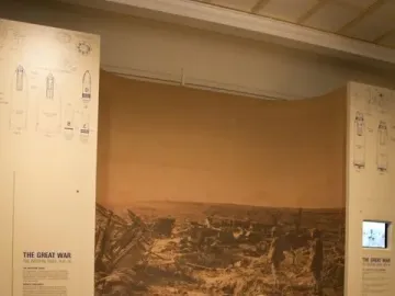 Man in the mud diorama showing a seated soldier in helmet surrounded by mud and debris, with a wartime backdrop and information panels.