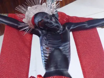 San Juan Patrón crucifix with a silver spiked crown and red drapery