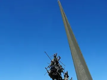 Vargas Swamp Lancers monument with charging horsemen rising from a white base and spire.