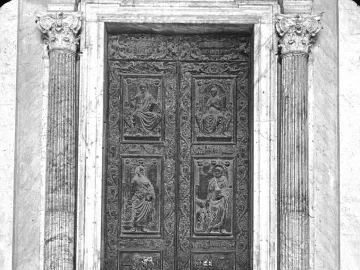 The Filarete Door at St. Peter’s Basilica, shown as an ornate set of double bronze doors with relief panels and fluted columns.