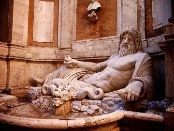 Marforio marble statue of a reclining bearded man in a stone basin