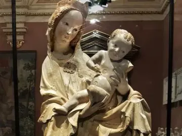 Krumlov Madonna sculpture of a woman cradling a child, with flowing carved drapery
