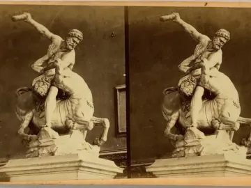 Heracles and Nessus marble sculpture showing a muscular man wrestling a centaur with a club raised overhead