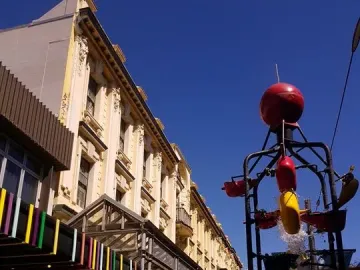 The Bucket Fountain with red and yellow buckets tipping water into a shallow pool in Wellington.