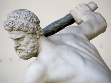 Heracles and Nessus marble sculpture showing a muscular bearded man in profile holding a club over his shoulder.