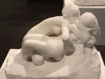 Metamorphoses, a white marble sculpture of two nude figures in an intertwined embrace.