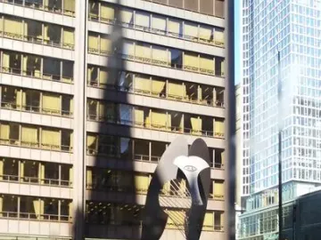 The Picasso, a towering abstract steel sculpture, stands in an urban plaza with benches and people nearby.