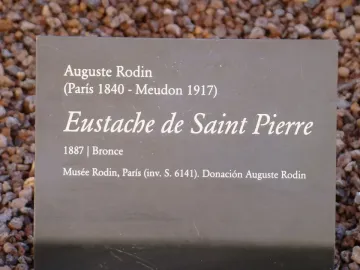 Informational plaque for Eustache de Saint Pierre with artwork details in white text on a grey sign.