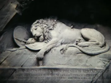 Lion Monument in Lucerne showing a dying lion carved into a rock grotto with a broken spear and shield.