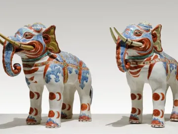 Pair of Kakiemon elephants in white porcelain with blue, red, and gold decoration.