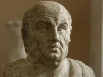 Weathered marble bust of Seneca with draped shoulders and the name carved on the base.