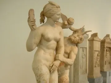 Marble sculpture of Aphrodite with Pan and Eros, showing a nude woman, a horned male figure, and a small winged figure in a struggle.