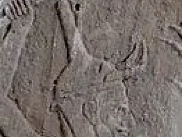Profile close-up of Baal with a horned helmet and raised arm.