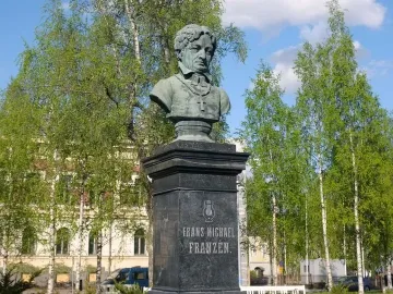 Bust of Frans Michael Franzén on a tall stone pedestal with carved lettering and a lyre emblem.