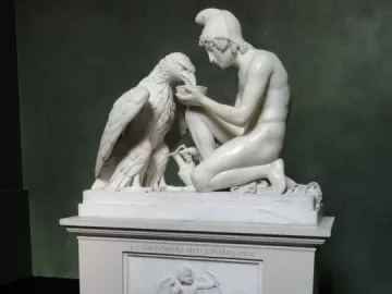 Ganymede with Jupiter\'s Eagle marble sculpture of a kneeling youth offering a bowl to an eagle