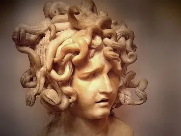 Bernini\'s Medusa in pale marble, with an anguished face and snakes intertwined as hair.
