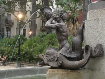 Bronze triton fountain detail from the Galceran Marquet Monument, with a merman blowing a conch shell.