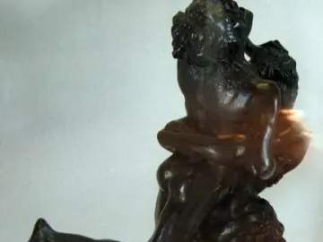 Hercules and Antaeus bronze sculpture showing two muscular figures in a struggle on a marble pedestal.