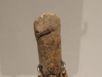 Immodest Venus mammoth ivory figurine with a slender female form on a dark stand