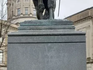 Granite pedestal for the John Brown Gordon statue with the name GORDON carved on the front and part of the bronze equestrian figure above it.