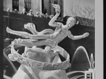Prometheus statue inside a large ring above a tiered fountain with cascading water and onlookers in the background.