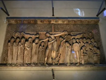 Stone relief of the Descent from the Cross with figures gathered around the lowered body of Christ.