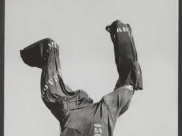 The Destroyed City sculpture, with an abstract figure raising its arms and a void through the torso, partially covered by cloth on a stone pedestal.