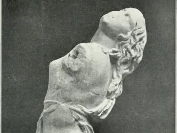 Dancing Maenad sculpture shown as a pale stone female torso arching backward, with wavy hair and draped fabric around the hips.