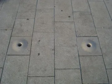 Stone tiles with two circular openings at the Sea Organ in Zadar