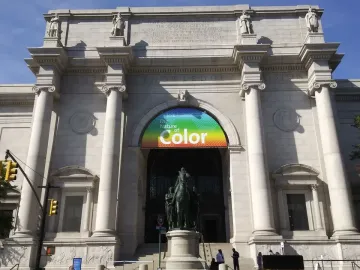 Theodore Roosevelt Equestrian Statue beneath a banner for The Nature of Color at a museum entrance.