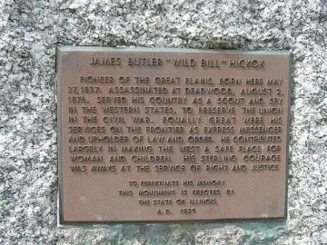 Bronze plaque on the Wild Bill Hickok Memorial with commemorative raised text on granite.