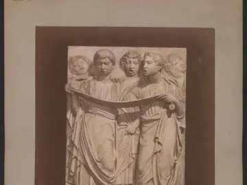 Cantoria relief sculpture with a choir of robed figures holding a scroll and singing.